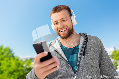 Image of young man with headphones and smartphone