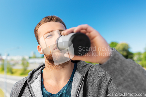 Image of young man with sports bottle