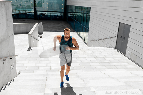 Image of young man running upstairs