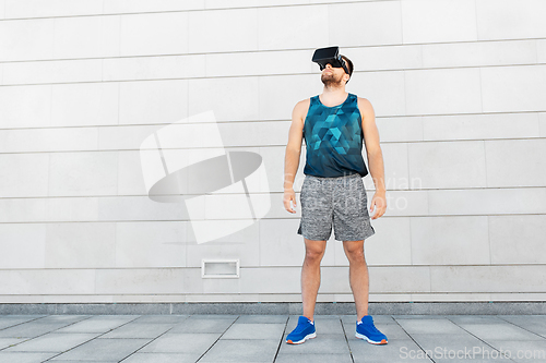 Image of young man in sports clothes with vr glasses