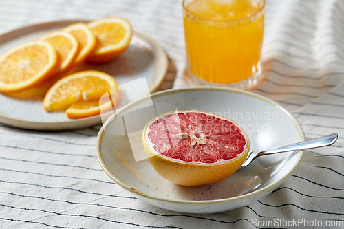 Image of grapefruit, sliced orange and glass of juice