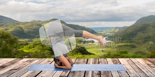 Image of woman doing yoga over Killarney National Park