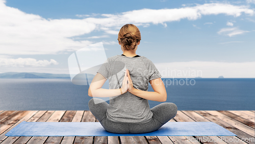 Image of woman doing yoga over atlantic ocean