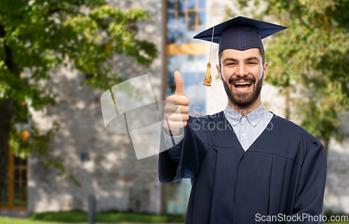 Image of happy male graduate student showing thumbs up