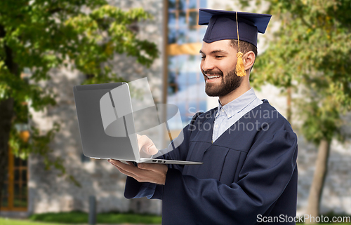 Image of male graduate student or bachelor with laptop