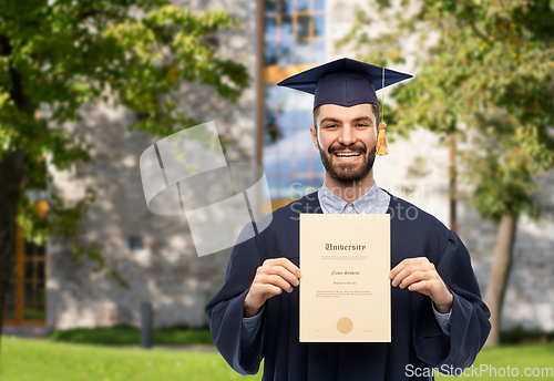 Image of male graduate student in mortar board with diploma