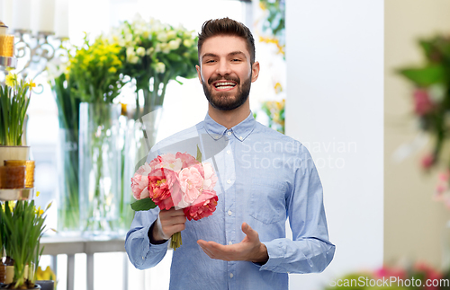 Image of happy smiling man with bunch of flowers