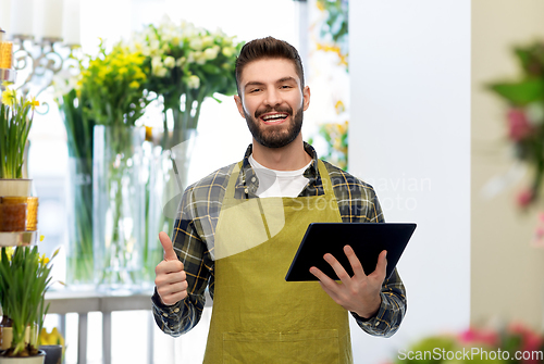 Image of happy male gardener or farmer with tablet pc