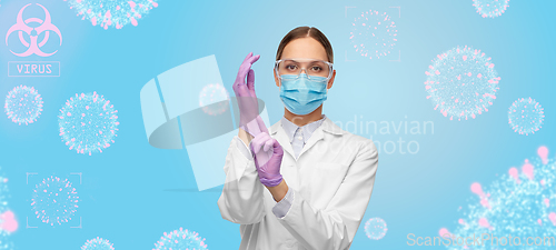 Image of female doctor in gloves, mask and goggles