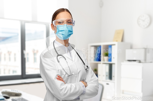 Image of female doctor in goggles and medical mask