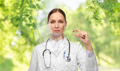 Image of female doctor holding medicine pill