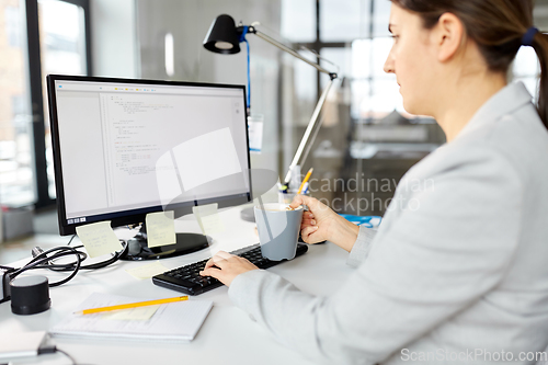 Image of businesswoman with computer working at office