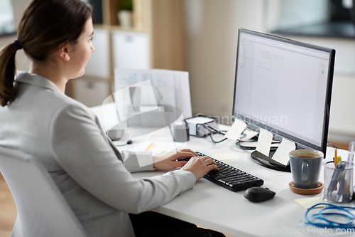 Image of businesswoman with computer working at office