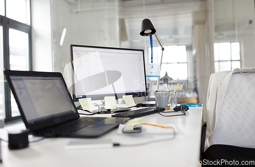 Image of laptop computer and gadgets on table at office