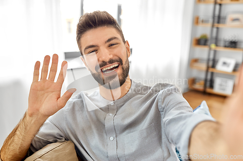 Image of man taking selfie or having video call at home