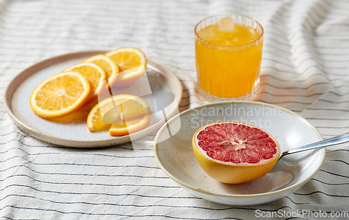 Image of grapefruit, sliced orange and glass of juice