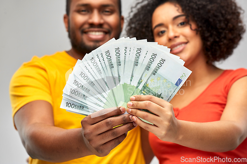 Image of happy african american couple with euro money