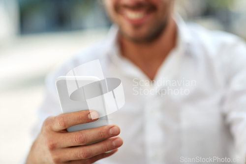 Image of close up of man with smartphone
