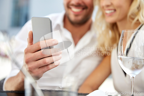 Image of happy couple taking selfie with smatphone at cafe