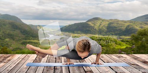 Image of woman doing yoga over Killarney National Park