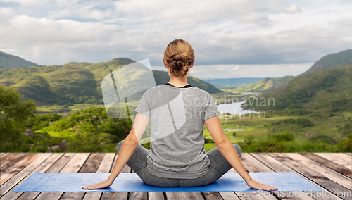 Image of woman doing yoga over Killarney National Park