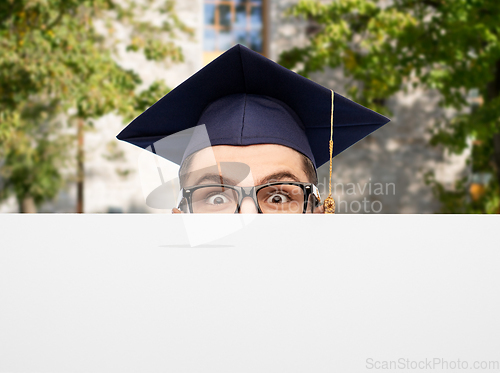 Image of graduate student or bachelor behind white board