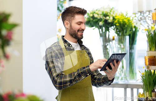 Image of happy male gardener or farmer with tablet pc