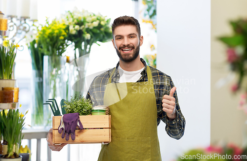 Image of happy gardener or farmer with box of garden tools