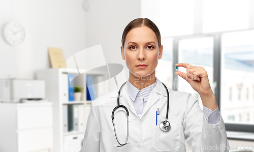 Image of female doctor holding medicine pill at hospital