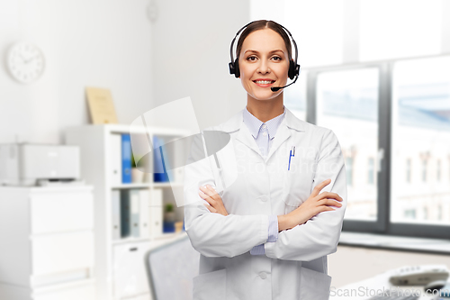 Image of smiling female doctor with headset at hospital