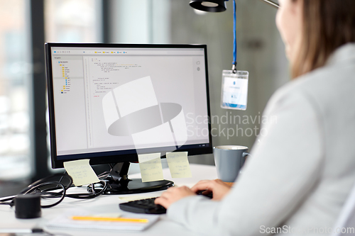 Image of businesswoman with computer working at office