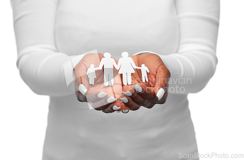 Image of hands of african american woman with paper family