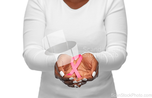 Image of hands of woman with pink cancer awareness ribbon