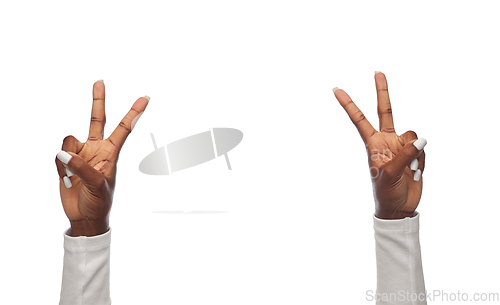 Image of hands of african american woman showing peace sign