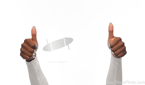 Image of hands of african american woman showing thumbs up