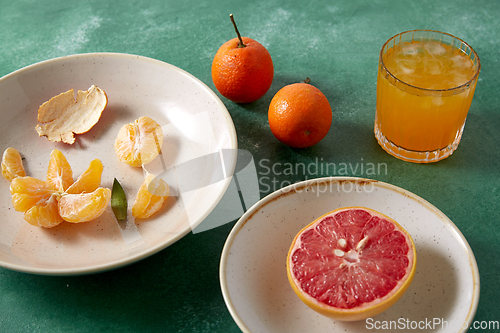 Image of mandarins, grapefruit and glass of juice