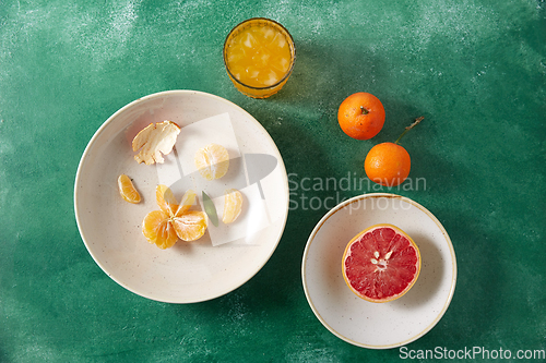 Image of mandarins, grapefruit and glass of juice