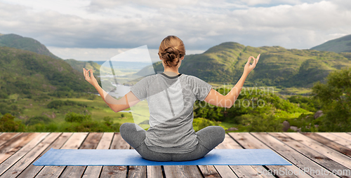 Image of woman doing yoga over Killarney National Park