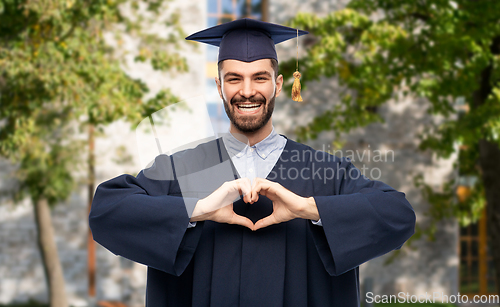Image of graduate student or bachelor showing hand heart