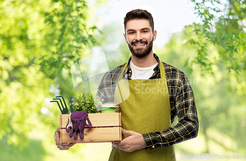 Image of happy gardener or farmer with box of garden tools