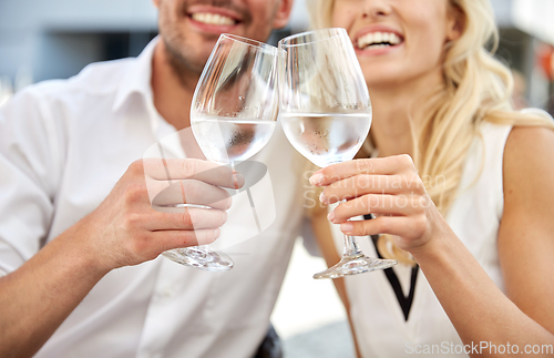 Image of close up of couple drinking water at restaurant