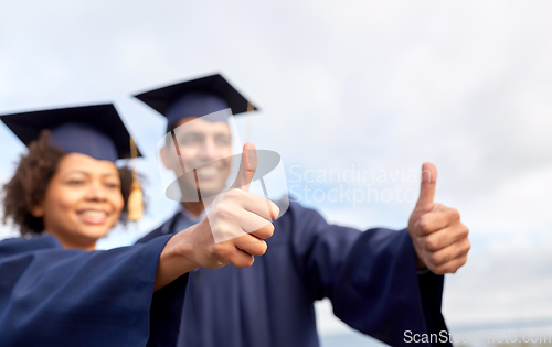 Image of graduate students or bachelors showing thumbs up