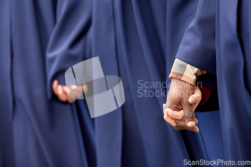 Image of close up of graduate students holding hands
