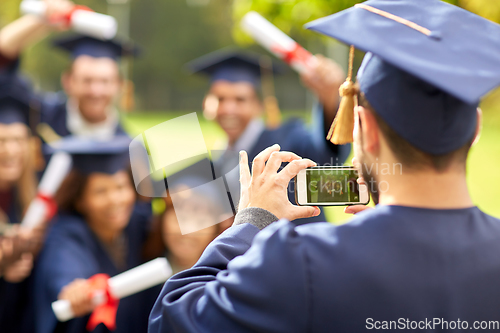 Image of graduate students taking photo with smartphone