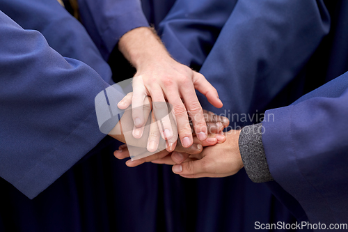 Image of inernational graduate students stacking hands