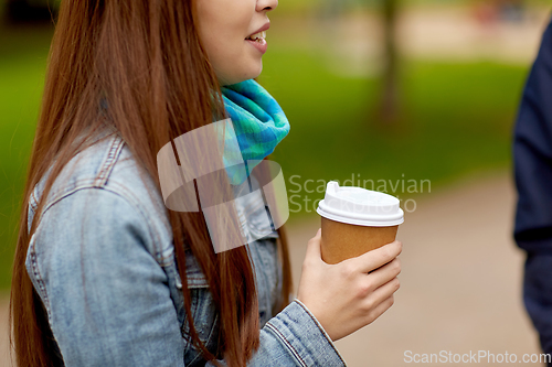 Image of close up of young woman drinking takeaway coffee