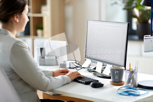 Image of businesswoman with computer working at office