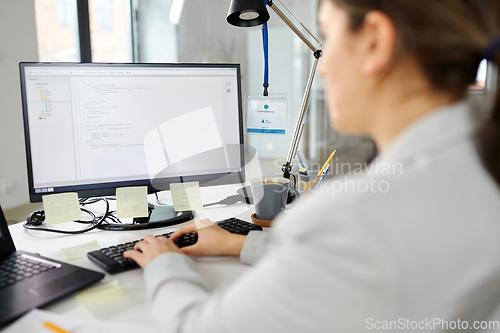 Image of businesswoman with computer working at office