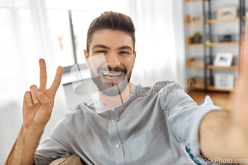 Image of man taking selfie or having video call at home