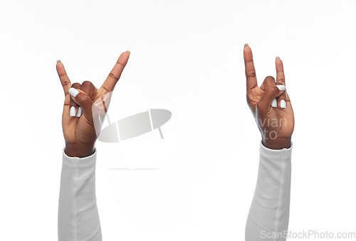 Image of hands of african american woman showing rock sign